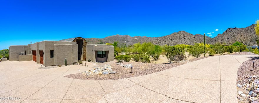Come and enjoy desert modern living at its finest. Custom home overlooking 13th fairway of the acclaimed Gallery North Course in Dove Mtn. and sitting on large .88 acre lot. Impressive architecture incorporates views of the surrounding mountains and desert landscaping in every room. Sliding glass window wall leads to expansive covered patio, heated negative edge pool, spa, built in bbq and golf course views. Three bedrooms are en-suite. Office/4th bedroom has separate exit. Alder cabinets, granite & slate counters, natural stone and wood flooring. *2023 updates include but not limited to: complete pool/spa remodel including 2 separate sets of equipment/heaters for pool and spa, new stainless BBQ, wood floors, interior exterior paint, ceiling fans, lighting, window treatments, roof coating, new high efficiency a/c and heating units, high end kitchen faucet and sink, ceiling fans and lighting, water softener system, RO system, garage door openers. Owner/Agent