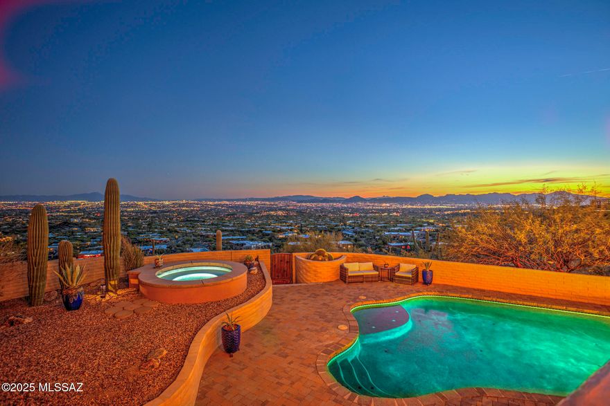 ''VIEWS, VIEWS, VIEWS! Nestled at the base of the Catalina Mountains with unobstructed panoramic city lights & mountain views, this classic foothills home offers peaceful privacy & one-of-a-kind morning and evening views of the grand fields of Saguaros peppering the slopes of the Catalina Mountains and Canyons. Near hiking trails, the famous Finger Rock formation, and 180° Tucson Valley views. This home has every fine touch finish imaginable! Classic Architecture, travertine tile and solid
Oak flooring, Beamed Ceilings, a Gourmet Kitchen to include custom cabinetry, SS Appliances, Wolf Range with 6 burners and grill, Bosch Dishwasher, Subzero Refrigerator and Wine Cooler, Pella Windows and Doors, Granite Counters and Island with Breakfast Bar. Call, text, or email for Drone Video Link. Outdoor Shower and Sauna! Owned solar with 2 Tesla battery backups! Owner has never had an electric bill since installation of solar system!