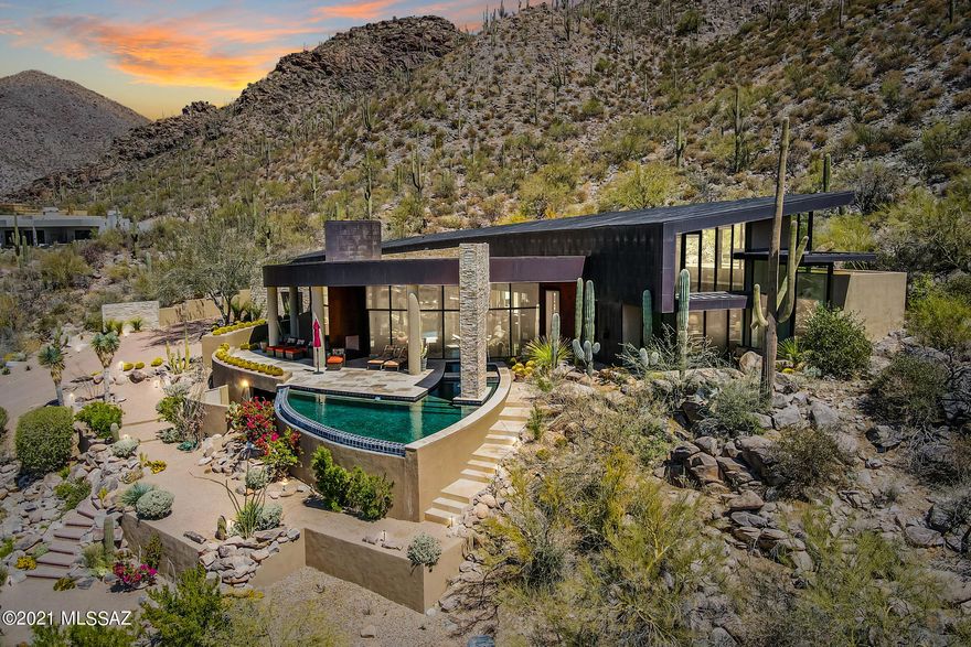 Designed by Kevin Howard and Interiors by Lori Carroll.  Come enjoy this incredible contemporary, one of kind, hilltop home overlooking the 5th fairway of the Gallery North Course (Escalante-Icon) Panoramic sunset views from this 2 AC property sits among dramatic rock formations & native saquaros. Sheets of glass capture the Sonoran desert and the floor plan is optimal for a large gathering or just private time. Master Suite and office split by Greatroom/Gourmet Kitchen & Breakfast area. 2 other BDRMS each w/ private baths anchor the other side of the home. 1/2 Bath for guests. The negative edge pool & spa are a show stopper. Additional seating areas area nestled in the natural desert.  Former Home of the Year in 2006. Call for your private showing. You will be overwhelmed !