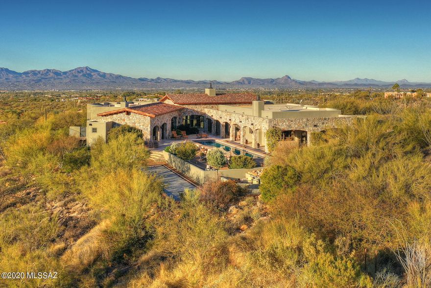 Undeniable European Elegance In This Ultra Private Estate in Coveted Pima Canyon. Perched on Over 2.5 Acres, This 5,826 Randel Jacobs Masterpiece Captures Commanding City & Mountain Views Throughout. A Gated Brick Paver Drive Leads To The Auto Court & Main Courtyard Entry. A Warm, Understated, Foyer Leads To The Grand Living & Dining Rooms w/ Exquisite Stone Work (harvested from the property), Wood Beam Ceilings, Hand Painted Murals, Walk In Wine Room, & Intimate Terrace w/ Fireplace. The Intimate Kitchen Features Wood Paneled & Hammered Copper Faced Appliances, Spacious Island, Hand Painted Mural, Butlers Pantry, and Indoor & Outdoor Dining Areas. Other Fine Features Include: Master Suite w/ Fireplace - Spacious Master Bath w/ Separate Soaking Tub - Two Walk in Closets, 3 Guest En suites, Media Room, Exercise Room w/ Cork Floors, Executive Office w/ Custom Walnut Cabinets,Travertine & Black Walnut Floors, Venetian Plaster Walls, Lap Pool & Spa, Intimate Covered Terrace w/ Fireplace, Regulation Bocce Ball Court w/ Crushed Oyster Shell Surface,  & Air Conditioned 3 Car Garage w/ Storage. This Is A Rare Opportunity to Own A Private Compound Within Pima Canyon Estates. Qualified Buyers Only.