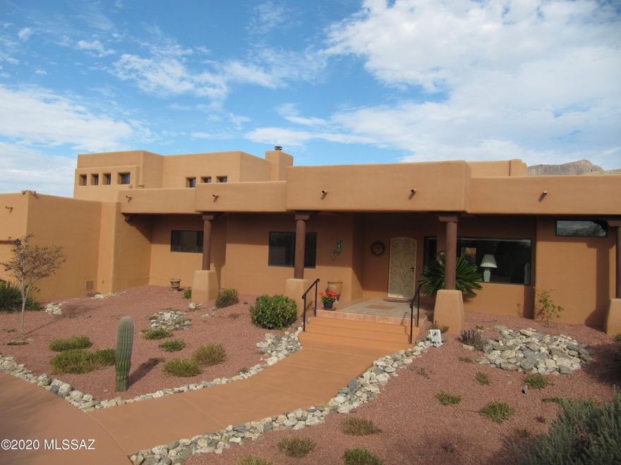 Located at the base of the Catalina Mountains w/VIEWS GALORE, North facing backyard on 3.46 Saguaro studded acres w/NO HOA, is the perfect home! This custom built Santa Fe home feats: Cathedral ceilings, Vegas & Beams, an open & spacious Greatroom design w/a formal dining area, huge Family Room & Kitchen w/breakfast nook! Kitchen feats:Granite counters, all new SS appliances, double ovens, gas cooktop, 2 large walk-in pantries, TONS of oak drawers, oak cabinets, 2 Lazy Susans & a desk. BIG Master Suite feats: Access to the backyard, Dual vanities, His & Hers walk-in closets, romantic see thru fireplace, jetted tub & big walk-in shower w/dual showerheads all w/charming Mexican tile! Home has 5 double security doors to the backyard, 4 gas fireplaces, Bose Home Theater thruout, skylights & ceiling fans thruout. AMAZING oasis backyard has sparkling self-cleaning Pebble Tec saltwater pool & spa, beautiful covered patio, beehive fireplace and built-in BBQ. All additional bedrooms are spacious, have large or walk-in closets, w/one having access to the backyard. The whole home is on 1 level, except for the huge loft bedroom w/a full bath  that overlooks the Family Room. Loft has a glorious porch that takes in the Mountain views & City lights! TONS of storage under the steps & there's an extra room off the gigantic laundry room! Laundry room has utility sink & room for an extra frig. More storage in the oversized 3-car garage w/skylights. Home has 4 zoned HVACs that are 2 years old w/maintenance agreements, reverse osmosis in kitchen & a full house water softener. Crisp & clean landscaping, Roof just re-coated April 2020. Tanque Verde School district! Rural living at its finest, just minutes to any shopping or dining! NO HOA!