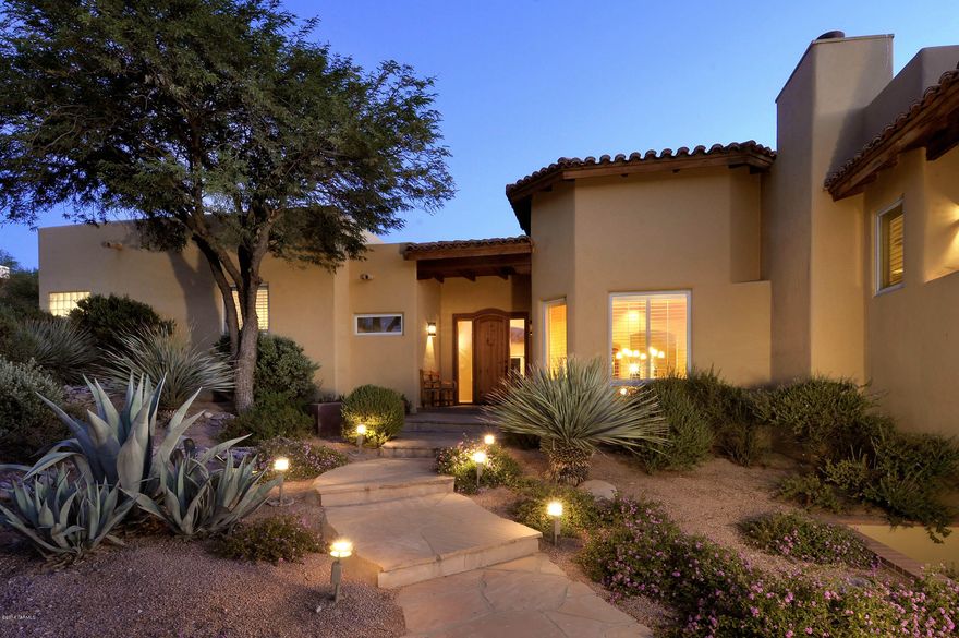 Outstanding and recently remodeled southwestern in prestigious, gated La Paloma Estates. Located on a quiet cul-de-sac with Catalina Mountain views, this quality home offers 8' rustic entry door into brick foyer opening to the living room with high beamed ceiling, hardwood floors, Rumford fireplace and mountain views. Remodeled gourmet kitchen features granite counters, cherry cabinets, stainless steel appliances, Wolf six burner cook top, hardwood floors and breakfast area. Brick floored family room with high planked ceiling and beams offers entertainment center & oversized fireplace. Master suite has fireplace & balcony retreat, master bath with slate floors and spa tub. Den with slate floors has built-in wine storage and custom sauna. Private rear yard features wood beamed covered porch