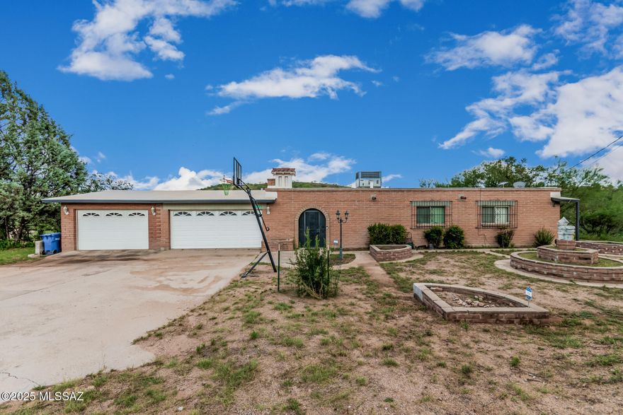 Look no further! This single-level charmer with a 3-car garage is the perfect one for you! Inside, you'll find a welcoming living room with easy-care tile floors, plus a family room with exposed beams, wood-look floors, and a crackling wood-burning fireplace. The kitchen is a true crowd-pleaser with stainless steel appliances, granite counters, a stylish backsplash, and cabinets galore. The primary suite spoils you with a walk-in closet, private bathroom, and direct access to the relaxing AZ room. Out back, a covered patio and oversized yard are just waiting for cookouts, games, or your dream outdoor oasis. Spacious front yard perfect for a landscaping view or creating a welcoming entrance to your home. What are you waiting for? Start enjoying lasting memories in this beautiful home!