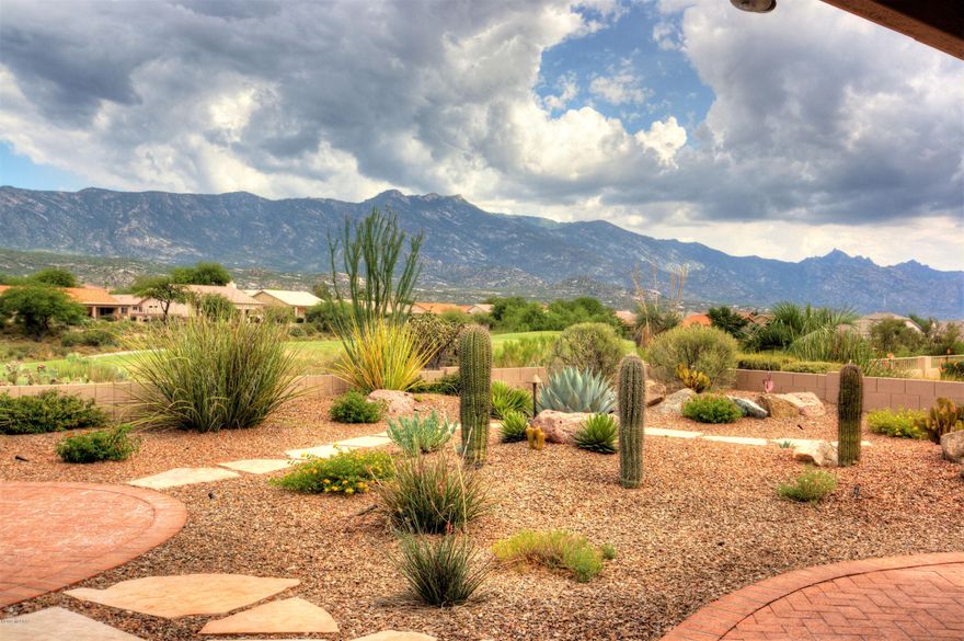 Beautifully updated Laredo on the golf course with unobstructed views of Catalina mts.  New, tile floors (20 inch) grace every room in the house. NEW HVAC system installed 7/2019.  Nothing to do, just move in and enjoy this special home. Updates to this home were mostly done in 2017.
New kitchen includes custom cabinets with under lighting, granite counters with travertine back splash, stainless steel appliances. Refrigerator new in June 2019. LED Lighting added, new sink, disposal and faucet.  Both bathrooms were updated with new cabinets, granite counters, new fixtures, mirrors & toilets. New tile surround for master shower. Plantation shutters throughout.  Culligan water system.  LED accent lighting and ceiling fans.  Laundry room with added cabinets/storage and granite counters. Since 2017 the following :
Exterior of home re-painted, New landscape lighting, New irrigation system installed, privacy wall at barbecue are with gas stub, outdoor ceiling fans on patio and exterior solar screens for windows.

Extended garage length with storage cabinets, pull down ladder to attic storage (floor & lighting) and utility sink.