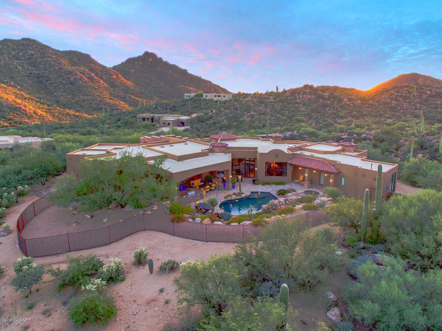 Tuscan masterpiece designed by Marc Soloway! Located in the guard gated community of Canyon Pass, this 4BD + entertainment room (6,026 sqft) home offers mountain & canyon views throughout. Enter & find walls of windows maximizing the views. Chef's kitchen with granite counter-tops, professional gas stove, double ovens & sub zero fridge. Great room with stone fireplace. Spacious master suite with fireplace, exercise room & luxurious bath. Entertainment room with bar & billiard area. 2nd master suite for guests. All guest bedrooms have private baths. Other features include wine cellar, Turkish travertine / Brazilian Koa wood floors & stone entry 4 car motor court. Resort back yard! Pool/spa, waterfall & fireplace. Outdoor kitchen with BBQ & bar. Minutes from Ritz Carlton & Gallery Golf Club.