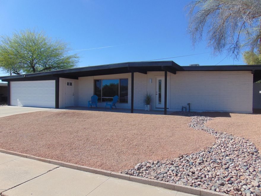 This GORGEOUS home has been COMPLETELY remodeled with the finest of finishes! Bamboo flooring! Oversized Tile! Madison Doors! Dual Pain Windows! HVAC!  Wood Tile Cover Patio! Full Custom Landscaping!  COMPLETELY.   Perfect floor plan encompasses four spacious bedrooms, two luxurious bathrooms, an open kitchen and a great room designed to entertain your family and friends. Quartz counter top with island breakfast bar, Carrera Marble back splash, new stainless appliances.  Two car garage with attached storage galore!   Enjoy the beautiful Catalina Mountain views from your open concept living space. Nicest home in  highly desirable east side neighborhood.