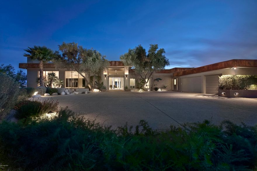Truly one of the finest contemporary homes in the Foothills on an unrivaled 4.52 acre gated hilltop lot with unmatched Mountain, City & Sunset views! This Minimalistic Desert Chic Contemporary home was built by renowned builder John Wesley Miller & has been recently updated to absolute perfection; uniquely embodying modern luxury & masterful design. Soft grey concrete floors accentuate the clean crisp white walls ideal for an art collection. The versatile floorplan features 5 spacious bdrm suites, 2 w/sitting rooms, den, 5 bathrooms, media rm & art studio. The open kitchen features top of the line appliances, custom cabinets & island. The lush lawn & terraced patios w/pebbletec pool & private cabanas are ideal for outdoor entertaining & provides an unparalleled setting. Private Well/NO HOA