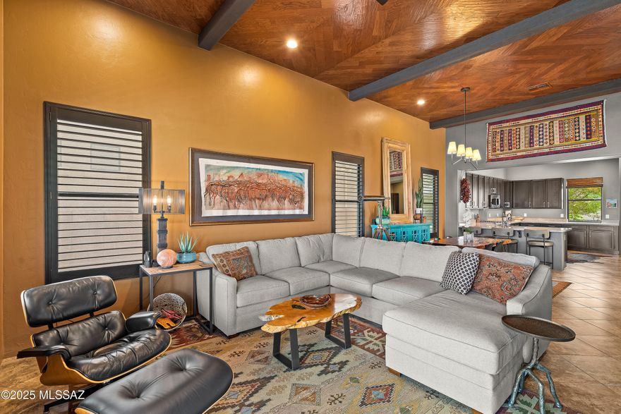 Designer-owned - for the Buyer who appreciates attention to detail - this stunning home offers two private courtyards, authentic Mexican tile, custom metal gates, and breathtaking Catalina views. Inside: chevron wood ceilings, a stone fireplace wall with mounted TV, wood shutters, and high-end finishes throughout. Chef's kitchen with gas stove, soft-close cabinetry, and filtered water system. Luxurious bathrooms with custom tile, glass showers, and California Closets in multiple rooms. Newly landscaped and updated front and back yards with new drip systems, extended patio pavers, lighting, invisible and snake fencing. Smart thermostat, tankless water heater, Kinetico system, epoxy garage floor, and more. A rare blend of design, function, and desert beauty.