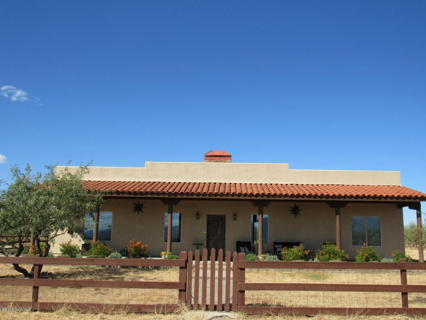Here's an absolutely stunning custom home on almost 10 acres. Privacy, views you dream of, and ready for you to call it home. Stained concrete floors, beautiful kitchen w/ granite counters, stone back splash, stainless appliances, walk-in pantry, breakfast bar, and opens to the living area, for the perfect entertaining environment. 9ft ceilings throughout home. The rear patio is paved and has access from the french doors and master bedroom. The front covered patio is ideal for enjoying the gorgeous sunsets and mountain views. 24x24 extended garage, high efficiency heat pump and water heater. Private well with a 2500 gallon water storage tank. 10 acres fenced, w/ 3 acres snake proofed. Country living at its finest. Bring your horses, bring your RV's, and be ready to love where you live.