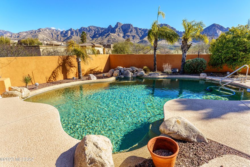 Make Your ''SOMEDAY'' Dreams Come True by snuggling into this choice setting with privacy, views, and space to breathe.  Located in a gated community in Oro Valley where space exists between homes and where the Catalinas and Pusch Ridge appear to be in your backyard.  (They sort of are!)  The patio, the pool, the bay windows with views from the dining area in the great room as well as from the primary bedroom, will make your heart smile.   It's easy to see that there are 4 bedrooms and the home is single story.  What's not easy to 'see' is what can  only be felt, by visiting this lovely home.  A place for new memories to be made.  With so many loving memories already within the walls of this beautiful home. . Spacious air conditioned garage with water softener enclosed in cabinet.  Some furniture for sale.  Estate sale planned for March 5th.  So, if you are interested don't wait to visit!
