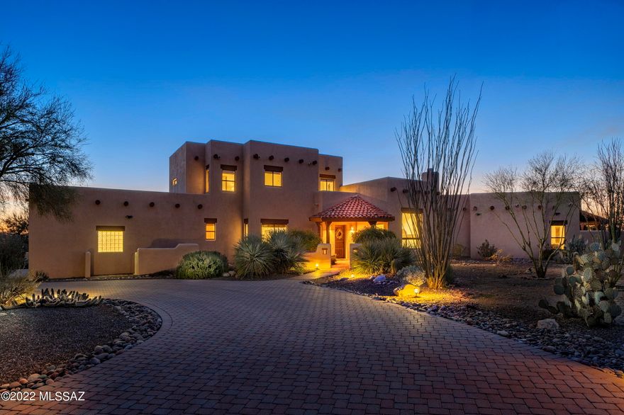 Wonderful Santa Fe on a spectacular, private view lot with mountain and sunset views and adjacent to the wash. This 4 BR/4BA gem features tongue and groove wood ceilings, beautiful vigas and corbels and views from every window,. Stunning newer eat in island kitchen w/SS appliances and quartz countertops which opens to the family room. Cozy living room with beehive fireplace and views of the Catalinas. Spacious Master Suite features fireplace, walk in closet, entrance to outside and is located downstairs. Step out to the large covered patio, perfect for entertaining and enjoy all the views. So much storage in this home, oversized 3 car garage with one bay designed for a RV. This gorgeous home has been meticulously maintained. Solar is seller owned.