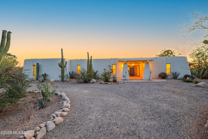 Experience the essence of high desert luxury in this stunning Southwestern-style retreat nestled in the prestigious Catalina Foothills. Set on a large, private lot, this elegant home blends seamlessly with its natural surroundings, offering complete immersion in the vibrant beauty of the Sonoran Desert. Ornate tile work accents every space, while traditional Saltillo tile floors lend timeless charm and warmth throughout.

Step outside to your own personal oasis featuring a sparkling pool and spa, surrounded by native flora and the soothing presence of desert wildlife. A private walking path winds gently down into a natural riparian area, where lush vegetation and seasonal rains provide a serene escape right in your backyard. This home is more than a residence—it's a desert sanctuary.