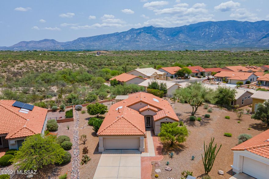 Move right in to your beautiful Sun City Dream Home. Expansive lot with panoramic views of the Catalina Mountains and professionally landscaped backyard. Enter into the great room with expanded kitchen that has been fully remodeled with beautiful cabinets, stainless appliances, farmhouse sink and granite countertops. Dining nook off kitchen has slider to back patio. Split bedroom floor plan offers two spacious bedrooms and 2 bathrooms. Slider off owner's suite also leads to back patio with stunning built-in kitchen which includes BBQ, fridge, sink & griddle. Your backyard oasis also has built-in fire pit, custom rock fountain and pergola.  New epoxy flooring in garage, new roof underlayment, new water heater, exterior paint & more. All furniture included in purchase price. Welcome home!