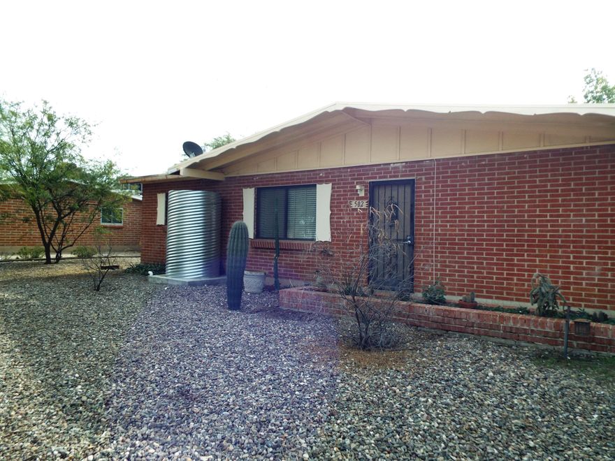 This updated brick home in north Tucson features 3 bedrooms and 2 baths. The kitchen has updated cabinets and granite counter tops. The baths have newer ceramic tile, vanities and upgraded fixtures. The flooring is diagonally set ceramic tile and easy care laminate. The home has green features including rain harvesting, tankless water heater, dual pane windows and solar power system. The rear yard has lush landscaping and a storage shed. The location is close to shopping, restaurants, transportation, Rillito Park and has easy access to downtown and the University.