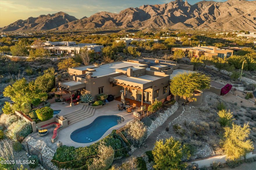 VIEWS! VIEWS! VIEWS! STUNNING CUSTOM SANTE FE BAIRD BUILDERS HOME IN DESIRABLE LA PALOMA ESTATES. THIS HOME IS 4231 SQ. FT. 4 BEDROOMS, 3 BATHS. LARGE OPEN FLOOR PLAN PERFECT FOR ENTERTAINING, FOUR FIREPLACES, MASTER SUITE WITH SPACIOUS SITTING AREA, KITCHEN HAS HUGE ISLAND, CHERRY CABINETS/WITH GLASS UPPERS, EUROPEAN HARDWARE, GRANITE COUNTER TOPS, SUB-O FRIDGE, GAS COOKTOP, SATILLO FLOORING, AUTHENTIC VIGA & LATILLAS CEILINGS, TOP OF THE LINE SOUND SURROUND, SOLID CEDAR DOORS, AMAZING CUL-DE-SAC LOT WITH CITY AND PANARAMIC MOUNTAIN VIEWS, FOUR HUGE PORCHES, POOL, SPA, NEW POOL DECKING, ROOF TOP DECK, NEW IRRIGATION SYSTEM, PUTTING GREEN, OWNED SOLAR, FIRE-PIT, BUILT IN SITTING AREAS, PROFESSIONALLY LANDSCAPED, COLOR STAINED DRIVEWAY,  TOO MANY UPGRADES TO LIST. THIS IS A MUST-SEE