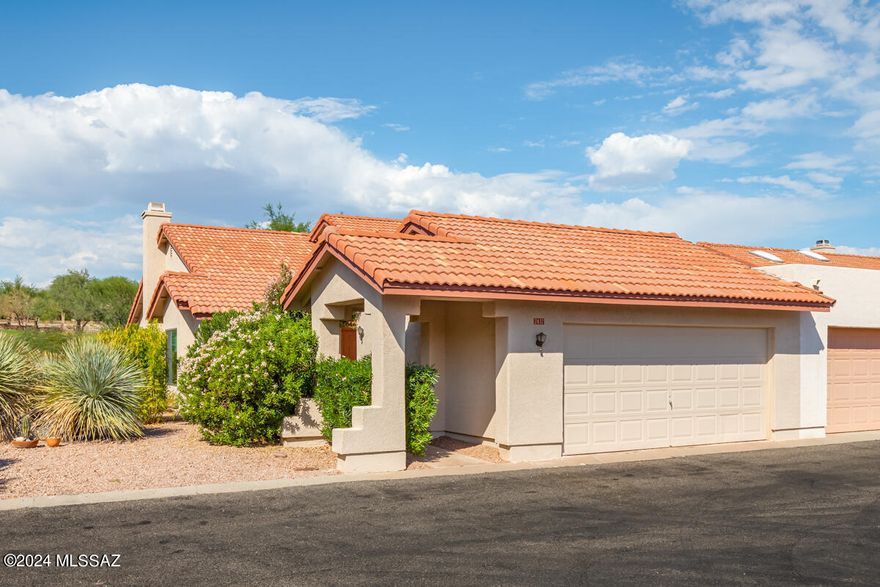 This is the One! Townhome inside the gates of Omni Tucson National. Located on the 4th green of the Sonoran Golf Course. This end unit sits at the end of a cul de sac with guest parking across the street for convenience. Light and bright with many large windows to let the flora and fauna of the desert in. Split bedroom plan with a wonderful AZ Room built for your comfort with air conditioning and heat to use in all seasons. Covered patio to sit and relax with a cold beverage and look out onto the course. 2 Car Garage! HOA covers many items to include pool/spa, landscaping, trash collection, streets and gate.