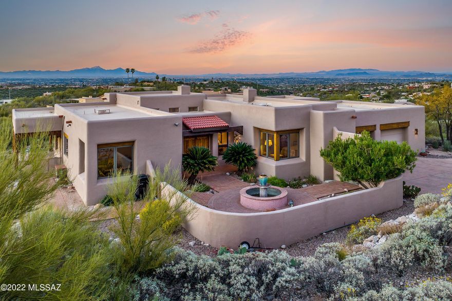 Live the Tucson Lifestyle!  Panoramic city and mountain view from every window!  Enjoy the beauty of this meticulously maintained hilltop Santa Fe home.  Front courtyard with a fountain surrounded by the mountain views.  Expansive wrap around patio to take in the views from every direction.  Easy access to shopping, hiking, and biking.  Close to Sabino Canyon.  Cimarron's 24 hour security patrol included in the HOA fees.