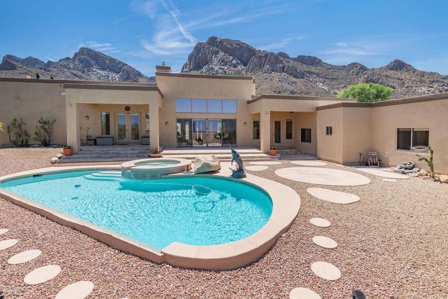 Spectacular mountain and city views accentuate this luxurious 4BD/4BA (4,258 sq ft) Custom Contemporary nestled against the Catalina mountains offering views from every room! This stunning hilltop home in guard gated La Reserve boasts a dramatic covered entry, grand foyer, soaring ceilings & skylights, large picture windows and oversized rooms perfect for entertaining. Formal Living room w/fireplace has retractable glass doors to bring the outdoors in. Adjacent Family room w/fireplace. Large open concept kitchen is ideal for gatherings. Master Wing hosts an owner's suite w/fireplace, room size walk-in closet, Jacuzzi tub & walk-in shower while beyond lies a Guest suite or office. Fresh exterior paint. Resort like rear yard boasts a sparkling pool/spa, fountain and serene views.