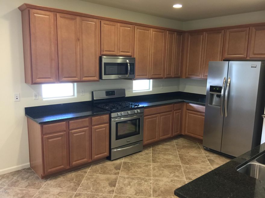 11448 East Dry Wind Drive Tucson, AZ 85747. Brand new never lived in 4 bedroom 2 bath Lennar home. Out of state investor bought it as a rental house and here is your chance to be the 1st people to live in the house. Almost $25,000 in upgrades and options for your comfort. Super luxury flooring and bath package to include better sinks and faucets, thick pad, quality carpet, and 20 x 20 inch floor tiles. Ceiling Fans and lights in all the bedrooms. It also included a gourmet kitchen with stainless steel appliances, granite counter tops, and recessed lighting. House also has 10 foot ceilings for the open feeling. Refrigerator and window blinds are included.