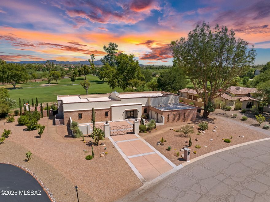Every element of this reimagined estate— from the artful lighting design to the meticulously selected finishes— reflects an unwavering commitment to luxury and refinement. The expansive open concept living areas are awash in natural light, effortlessly blending indoor comfort with the vibrant outdoor scenery, including the sparkling pool, lush landscaping, and the sweeping vistas of Tucson National's 16th and 17th fairways. Whether you're hosting an intimate gathering or a grand celebration, this residence offers an exquisite setting for unforgettable moments. Smart home technology enhances everyday living with seamless comfort and convenience, while the serene surroundings provide a tranquil retreat from the ordinary. Originally built in 1964 and thoughtfully redesigned by renowned architect Marc Soloway, the home retains its timeless charm while embracing modern sophistication. The renovation delivers everything today's discerning buyer desires: soaring 12-foot ceilings that frame breathtaking views, expansive outdoor living spaces, cutting-edge features, and luxurious details such as 4-foot porcelain tile flooring and motorized draperies. The gourmet kitchen is a true showpiece, featuring a dramatic tile accent wall, striking black vent hood, custom cabinetry in contrasting tones, a hidden walk-in pantry, ice maker, six-burner gas range, and an abundance of quartz surfaces. Floor-to-ceiling glass walls along the rear of the home dissolve the boundary between indoors and out, showcasing the spectacular golf course backdrop. Enjoy chilled drinks on the patio, cozy evenings by the fireplace, refreshing swims after a round of golf, and effortless entertaining in a home designed to delight at every turn. This is a rare opportunity to own a masterfully reimagined estate in one of Tucson's most coveted golf communities.