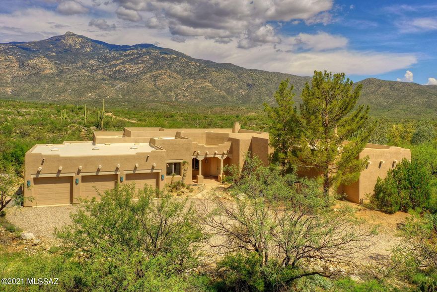 ''A River Runs Through It''  This truly stunning 3,709 sq. ft. Southwestern-style home is nestled on 45.5 heavily-wooded acres with Chimenea Creek running through it, conveniently bordering Saguaro National Park East.  The unique property is located in guard-gated X9 Ranch (minimum lot size in X9 Ranch is 36 acres) for the utmost privacy! Surrounded by waterfalls, majestic saguaros, towering mountains, a mesquite bosque, a boating area on the creek, and breathtaking Rincon Peak views. Highlights include a covered entry, a great room with walls of windows & a beehive fireplace, soaring viga beamed ceilings with corbels, flagstone flooring, Butler doors, art niches, and all wood-clad dual pane windows with cedar headers & rolling shutters.