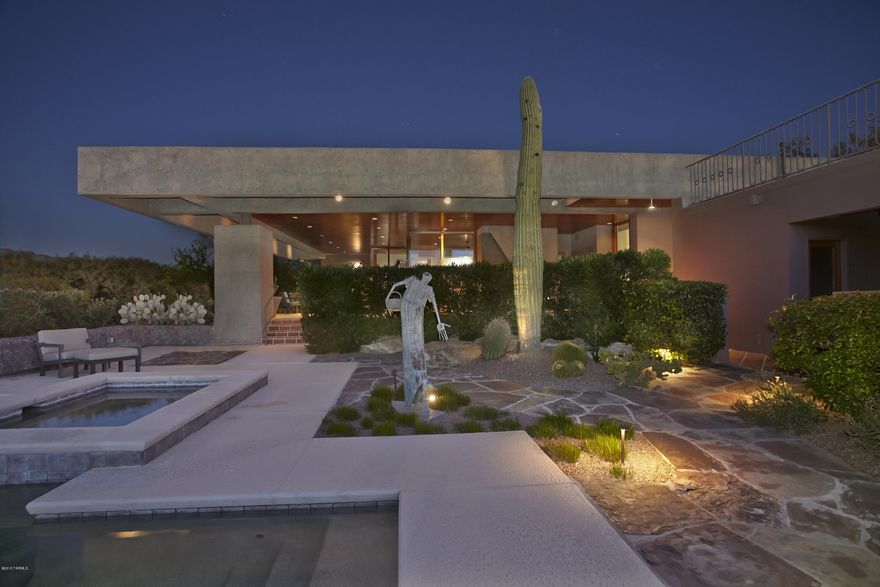 This Spectacular Contemporary is Beautifully Sited to Enjoy all the Natural Pleasures Tucson has to Offer. The Genius of Award Winning Architect Les Wallach Designed and Provides a Perfect Blend of Strength and Beauty. Prime 2 Acre Ridgetop lot with Majestic Catalina Mountain and Sunset Views. The Dramatic Entry Foyer's Hand Quarried Stone Walls with Select Wood Ceiling and Floors Graciously Flow into the Formal and Informal Living Areas. Soaring 80 ft. Aggregate Concrete Beams Frame the Exterior Elevations. Walls of Glass. Expansive Outdoor Entertainment area with Built in BBQ, Fireplace, Pool Bath, Custom Swimming Pool with Spa and Waterfall. Make an Appointment to See this Truly Special and One of a Kind Property.
