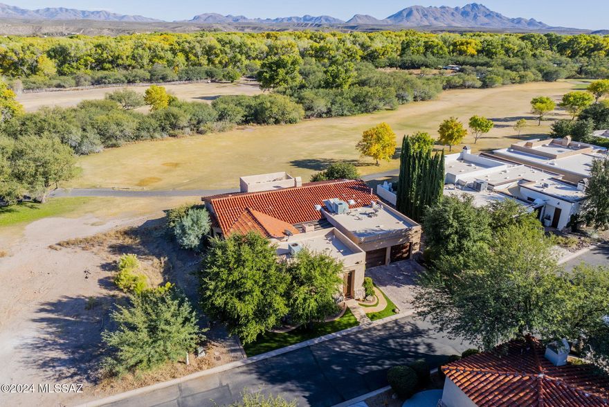 Nestled on the picturesque Anza Hole 1 of the renowned Tubac Golf Course in the heart of Tubac Golf Resort, you'll find the perfect blend of luxury, privacy and natural beauty. Multiple pergola-covered and open courtyards are topped by one of this home's most striking features: the skydeck, a tranquil haven where you can take in panoramic Santa Rita Mountain views. Great room features exposed beam ceilings, cozy fireplace, and beverage station. Kitchen features custom cabinetry, tile backsplash and seated bar plus adjoining informal dining space. There's also a formal dining room and additional flex space. Two spacious en suite bedrooms have been designed for comfort and style. Private casita with separate entrance and private patio is an ideal retreat for guests or multi-gen households