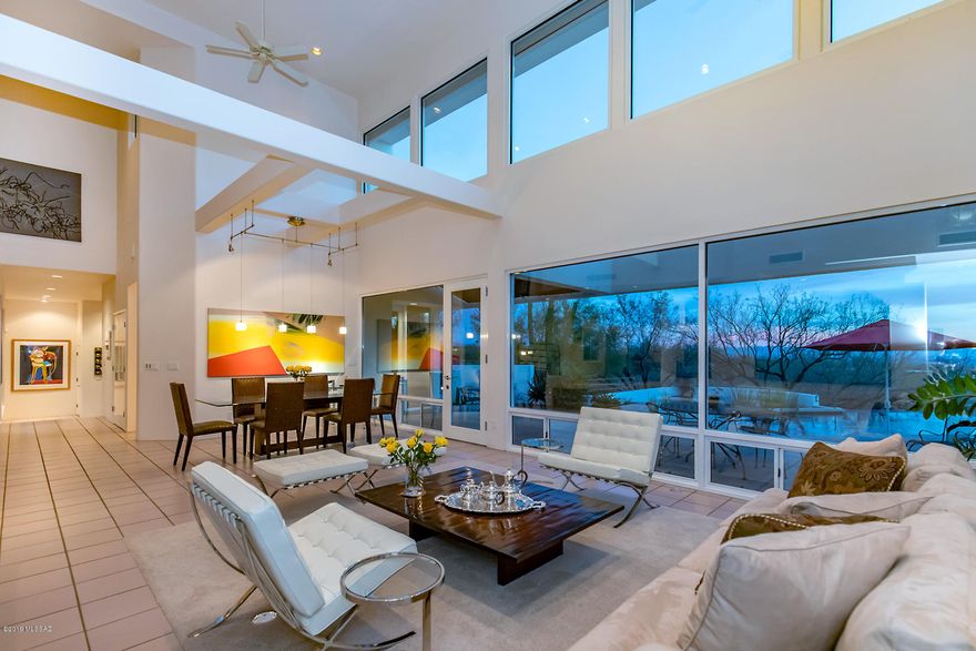 Nestled in the Coronado Foothills, well-constructed CONTEMPORARY home designed by Don Kornberg. A taste of QUIET ELEGANCE & PRIVACY. Lush desert vegetation, MOUNTAIN VIEWS & CITY LIGHTS merge naturally w/ the flow of light & space within this home. Vaulted clear story Living & Dining room, Family rm w/ fireplace framed by TALL WINDOWS make the majestic Catalinas the backdrop. Remodeled kitchen w/ SPACIOUS QUARTZ CENTER ISLAND, Sub-Zero, & double oven. Updated pebble tec pool & front courtyard entry. Mst suite w/ fireplace framed by city lights, DEN W/ VIEWS to the city/lights can easily be converted to a 4th bedrm, alcove can serve as a nook for a desk/computer area. SECULDED HOME, roof deck w/ sunset views, negative edge pool, central vac .