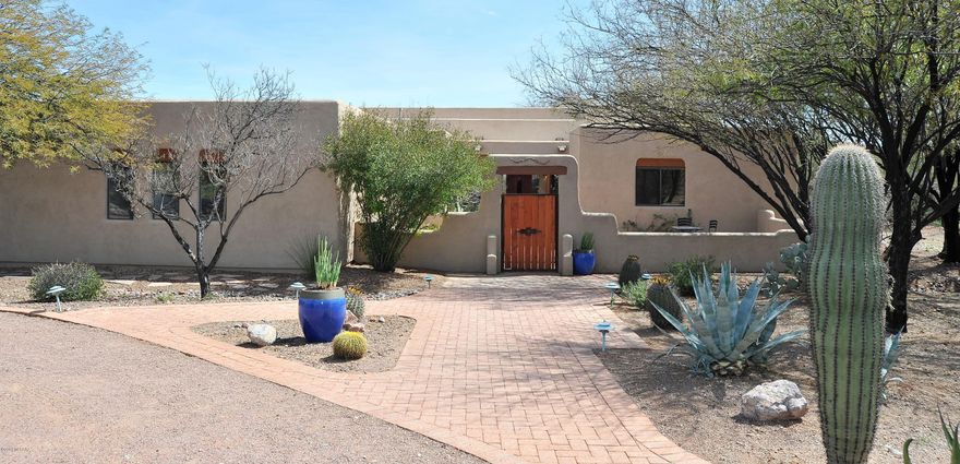 Gorgeous and spacious 3bedroom + den home sitting on an acre lot in West Tucson!  This Southwestern gem in the highly desirable Silverbell Hills Estates is a must see with great features and upgrades to include:  New paint throughout, New Granite Counter tops in Kitchen and powder room, New faucets in both kitchen and powder room, beautiful New Carpet throughout, New water heater, gorgeous updated landscaping in the back yard, Automatic sprinkler system, Stunning exposed wood beams adding the perfect touch to the Santa Fe style charm, Spacious great room with High Ceilings, Sparking Salt Water Pool, relaxing Private front court yard, Oversized 3 car garage with lots of storage and workshop area, lovely circular driveway and so much more!  See it for yourself today!