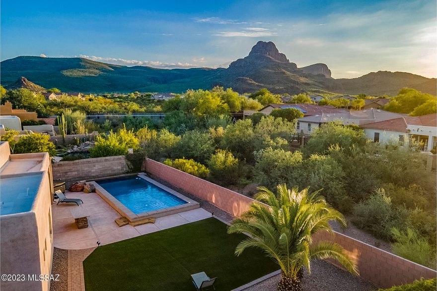 Located in Continental Reserve, 8107 N Night Pony Drive blends a setting that showcases the beauty of the desert with community living, proximity to amenities and easy access to roads for commuting. Situated on a large, private pie-shaped lot with open space behind, you will find compelling views of the Tucson Mountains and incredible sunsets. Outdoor living is at the forefront here. The generous custom designed ozone pool includes both elevated zones for relaxing or play, along with deeper water and a swim lane for laps. Additionally, residents will enjoy a separate hot tub, built in speakers, an outdoor kitchen with pizza oven, and multiple zones for seating and gathering. A Santa Fe style exterior with wood beams and clay sconces feels authentically Southwest. The home is set back from the road nicely with an extended driveway, creating plentiful parking for guests.

Inside, the open layout features high ceilings in the great room and large windows letting in ample light. The chef's kitchen includes granite counters, a built-in wall oven, pull outs in lower cabinets, reverse osmosis, and a gas cooktop. A sliding door in the primary suite provides quick access to the outdoors and mountain views are enjoyed from this space. The home is kept cool with a new, high end HVAC system (installed in 2022).

The Continental Reserve neighborhood offers residents many wonderful lifestyle elements. Sidewalks are available for walking and in just a couple of minutes you will reach the Passey Loop Trail for a scenic and easy hike. Under a mile away sits the elementary school and community park that includes ball and soccer fields, a tennis/pickleball court, basketball court, playground and ramadas.

Outside the neighborhood, conveniences galore are available. Within 5 minutes there is a wide variety of retail, grocery, restaurants, fitness facilities, movies, golf, a dog park and more. For walkers, runners & cyclists, access to "The Loop" 135-mile paved multi-use path is 1.5 miles away. Equestrian lovers will find several different stables in the area for riding & lessons, while hikers and mountain bikers have the Tucson Mountains at their fingertips. Traveling to Tucson's major employers is made simple with quick and easy access to I-10.