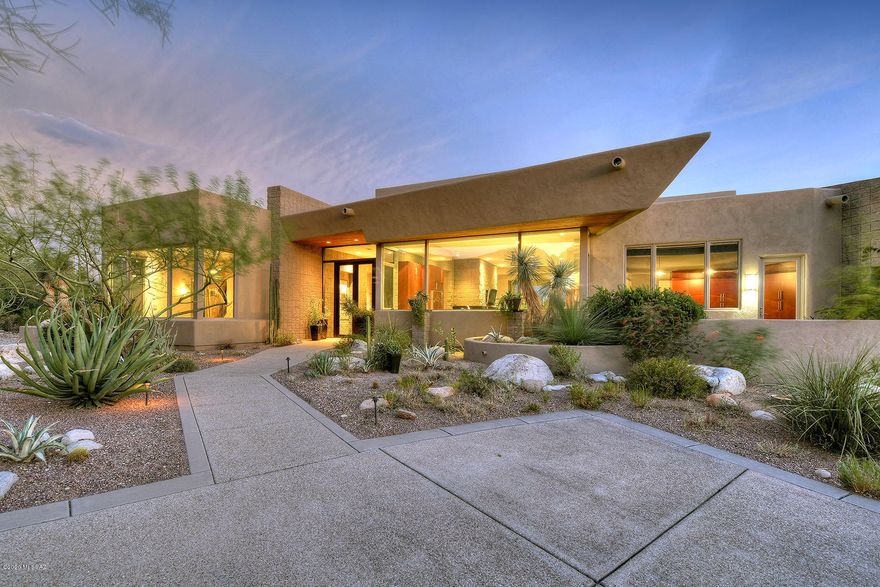 Zen meets an amazing array of amenities and designed to flow seamlessly from inside and out.  Fall in love when you walk in the front door & gaze through the wall of windows transporting you to the resort-style outdoor space w/pool, spa and outdoor kitchen. Enjoy Tucson's lifestyle entertaining poolside w/a glowing fire and grilling in built-in BBQ area. The kitchen with adjacent butlers pantry/catering kitchen is a chef's dream with commercial grade appliances, a unique center island, 3 dishwashers, Wolfe range, Sub-Zero refrigerator & freezer and elegant granite and slate countertops.  Master suite competes with finest resorts &  includes an outdoor shower, spacious walk-in closet, slate floors and accents and separate vanities. Home is perfect for multi-generational living w/separate guest suite featuring a den and 2 BRs/2BAs  The study or 4th BR, is spacious and has fabulous mountain views.  Designed by renowned Marc Soloway & built by Lathrem Homebuilders, this home exudes quality and attention to detail.