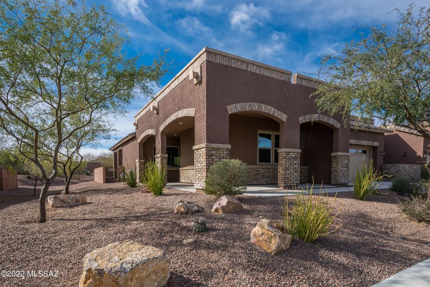 Located in the heart of the Oro Valley, Ridgeview at Vistoso Trails is a small gated townhouse  enclave  of luxury homes. This end unit townhome with stack stone trim and side entry welcomes you to a comfortable and casual great room floor plan. Interior features light and bright living spaces with mountain views from great room. The kitchen is the heart of the home with large island perfect for cooking prep & gathering with friends and family. Split bedroom plan offers owner and guests their own private spaces. Back yard is enhanced by  fountain, desert plantings and fruit trees all to be enjoyed from oversized patio. Electric on Patio upgraded for spa.  HOA amenities include Pool/Spa/firepit/seating area, Front yard maintenance, Roof coating/sealing, Exterior painting.  Welcome home!