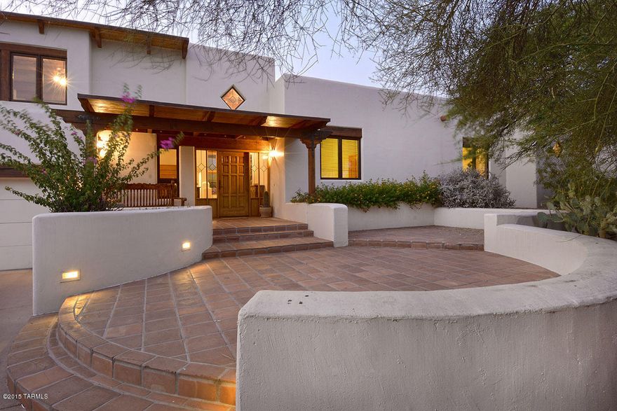 ''Expect the Unexpected'' This home could of only been built by a native Tucsonian. 
Masonry, huge patios facing the Catalinas, outdoor living that was designed for everyone, and the best...solar!Soaring ceilings, numerous doors to patios, and still pay so little for electricity! Of course AC,& evap as well.5th bedroom is beautiful office currently.Sitting in the heart of the foothills, in a secret little neighborhood, and yet minutes away from everything.  I can't begin to describe the equally amazing inside.  Tile floors, thick walls, niches, and a prevailing feeling of one space leading to another. The majority of the home is on the main level but don't miss the huge ''extra'' living upstairs, of course with a private upstairs patio for city views!I love this one...can you tell?!