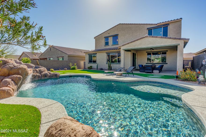 Gated 5 bed/4 bath Family Home has it all! Popular Meritage Floor Plan - Sonoita.  Huge Owners Suite with Catalina Mountain Views. Resort style yard w/ Heated Pool, Rock Water Fall Grotto, Hot Tub and more. Cook's Kitchen with Matte Monte Cristo Granite Counters and Island. Multiple Living Spaces Throughout. Close to all your Oro Valley favorites!  Walking distance to Wilson K-8 & Ironwood High.  Don't miss this one!
