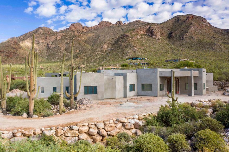 Stunning brand new contemporary w/6099 sq.ft to be completed February 2020. Breathtaking mountain views in prestigious gated Pima Canyon. Exquisite foyer entry w/wrought iron front doors, dramatic 16 ft. ceilings, elegant living rm w/fireplace, walls of windows, formal dining rm, gourmet island kitchen w/quartz countertops, stainless appliances, gas top range, double ovens, 2 dishwashers, 48 '' refrigerator/freezer, breakfast area opens  to family rm w/fireplace, gorgeous marble flrs,Pella windows, 8 ft &10 ft. doors,4 BR's + study or 5 BR's & 4.5 BA's. Master w/fireplace, lux bath w/quartz countertops, 
marble flrs, Jacuzzi tub, rain shower,large walk in closet & priv. entry to patio. Gracious bkyd w/ cov'd patio,pool,spa,grass,4 car garage & mtn views. Flr pln under photos/virtual tour.