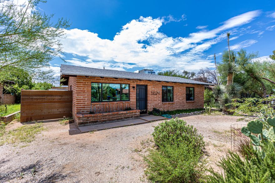 Wonderfully updated, super clean and move in ready burnt adobe home in Central Tucson!  Easy access to 5th or Speedway, means a short 10-12 minute drive to the U of A!  Huge lot with a large workshop and storage area in backyard.  Fully fenced backyard with new corrugated metal fence.  Kitchen is new with stainless appliances including gas range, dishwasher and black refrigerator.   Island with wood top and drawer storage.  Doggie door in place for your pets. New dual pane windows, newer HVAC & Roof, new doors, tile floors, paint, entry doors.  Bath is fully remodeled with custom tile shower and updated lighting, fixtures and floors.  Finished laundry room off back patio with new water heater.  Washer and dryer included.  Great backyard space with mature landscape & large storage building.