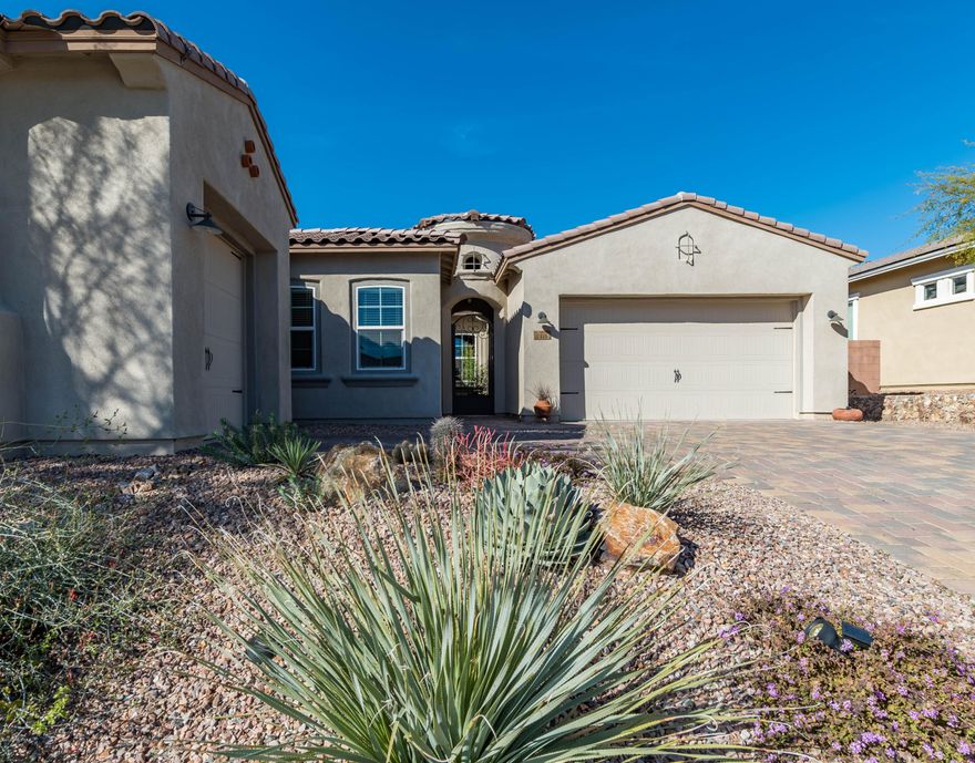 Gorgeous Cimarron Model features charming interior pavered portico & courtyard. Bright & airy foyer leads to huge open great room. Stacked sliding glass door offers breathtaking mountain & saguaro views. Gourmet kitchen is a dream with tiled backsplash, 5 burner gas cooktop, double oven, walk-in pantry, wine fridge, & granite counters. Private master suite w/coffered ceilings, beautiful mountain views from picture window, & large walk-in closet. Pamper yourself in this beautiful master bath w/walk-in shower,dual sinks. & garden tub. Large laundry rm w/ great counter space & full storage cabinets. Tandem 3 car garage & separate 4th car garage, plus a fire suppression sprinkler system. Backyard is complete w/covered patio, professionally landscaped, plus a fireplace. Close to hiking trails.