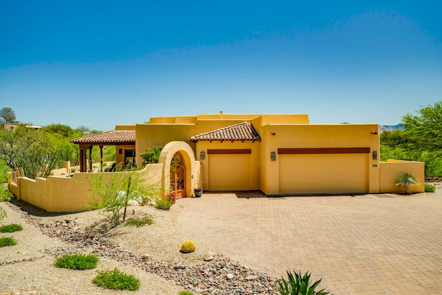 From the moment you enter through the courtyard gates you will be amazed by everything you see!  This home is perched on a unique lot with remarkable views in all directions.  Enter through the solid wood door and you'll find spatial elegance where a wall of glass in the great room takes center stage and a corner Kiva style fireplace adds a flare of southwest living.  The traditional dining room displays ornate post and beam décor and a classic recessed ceiling and chandelier.  You've finally found your dream kitchen with dazzling granite countertops, a large prep-cook island, stainless appliances including double ovens, ornate wood posts and Vega beams overhead.  A convenient eating nook is tucked within bay windows displaying terrific views.  Your huge master bedroom suite gives you a quiet sitting area with bay window views plus a garden door providing direct access to the covered patio.  Spoil yourself in luxury in this immense master bath with separate "his and hers" granite covered vanities, custom lighting fixtures, framed mirrors and a curved glass block shower.  Catch up on your reading in the den with electric fireplace, media center and built in bookshelves.  Step outside where the outdoor living spaces are just as incredible!  Sitting on a 1.6 acre lot that is like your own island you will have panoramic views from several sitting areas - choose from the north patio; the covered east patio or the south patio which has oversized glass panels for terrific viewing!  And the 6KW Solar system will keep electrical costs to a minimum.  An absolutely incredible property!