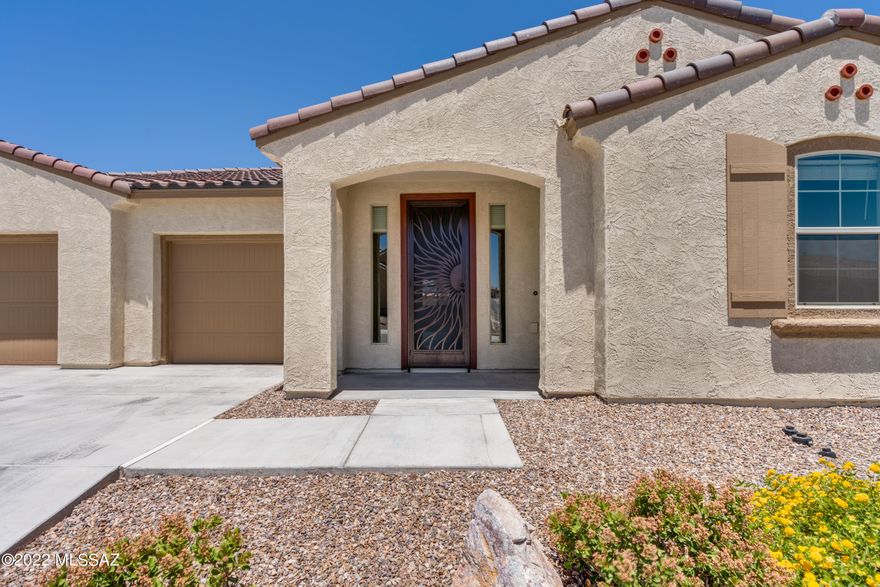 SELLER TO ACCEPT OR COUNTER OFFERS BETWEEN $575,000-600,000.  Why wait? MOVE IN NOW! IMMACULATE 2021 Mattamy SINGLE STORY 4 bd/3 ba 2617 sqft  3 car garage home! Custom door opens to light & bright grand foyer with wood plank tile, bonus room & upgrades galore! Custom built-in entertainment center w/TV in great room! Wood blinds, ceiling fans & recessed lighting throughout! Kitchen boasts huge granite island, gorgeous backsplash, wall convec/micro & wall oven, gas cooktop, all SS appls; massive pantry, eat-in area plus dining room (or exercise, den, office bonus area). Full North back patio covered w/ turf and views of the Rincon Mtns!  Primary bedroom with spa-like shower, separated dual vanities and oiled bronze hardware!  Cont'd- Other details include 2-toned paint, mud/drop area, suspended storage and epoxy floors in garage, rain gutters and washer/dryer included! Don't forget the amazing community of Saguaro Trails with incredible community pool, playground, sports fields, ramada & BBQ, dog park and sidewalks! Must see!