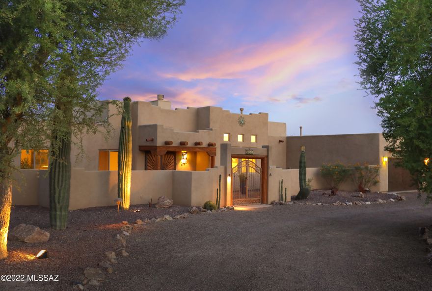 Only for those who love spectacular Catalina Mountain and sunset views!  This classy, custom Santa Fe home is situated in NW Tucson on a 1.3-acre private corner lot. Enter the gated courtyard and step through the dramatic double security doors into the bright, open living space with high coffered ceilings, niches and a plethora of architectural details. The large kitchen features granite counters, breakfast bar, custom cabinets, gas range and adjoins a spacious great room. Full laundry room has folding area, cabinets and utility sink. Two spacious primary suites have access to the backyard oasis with heated pool/spa, waterfall, flagstone patios and raised flower gardens. There is even room for an RV with 30-amp service. You won't want to pass this one by!