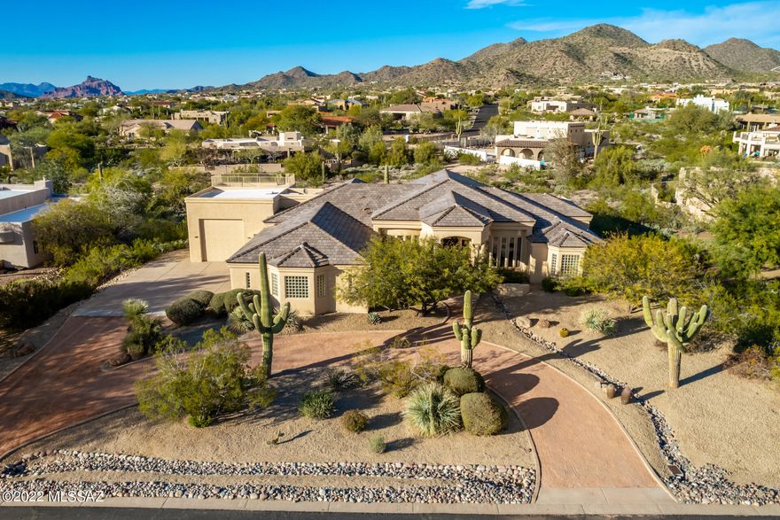 Absolutely IMMACULATE & UPGRADED 4 bedroom / 3.5 bath home with RV GARAGE in the highly sought-after Northeast Mesa gated subdivision of Thunder Mountain Estates. This one of a kind designer home features too many upgrades to mention...all new carpet, fresh neutral paint, new lights, fans & fixtures, water softener and BRAND NEW flat tile roof with warranty. From the moment you enter the gorgeously stained wood & beveled glass front door, the large formal dining & living room welcomes you home. The upgraded kitchen features new white & onyx black soft close cabinets, new quartz countertops, custom kitchen island with breakfast bar, touchless faucet, new GE Café appliances, Herringbone backsplash, walk in pantry and eat in kitchen. The extra family room features designer black & white touches with a wet bar, drink AND wine fridge, perfect for entertaining right off the kitchen! As you enter the master retreat, you will find a built-in coffee nook with a sitting area & gas fireplace. The master en-suite is your own personal spa with his & hers walk-in closets, dual quartz vanities, separate Roman tub with jets, large double walk in shower and private toilet room. Two additional bedrooms share an updated jack & jill bathroom, and don't forget to check out the ladder room with its very own hidden loft! The 4th bedroom has it's very own en-suite & closet. Do not forget the laundry room with sink on your way to your new upgraded & oversized garages. You will find new graphite epoxy garage floors, tons of storage, extra sink, and RV garage with two oversized (pull through) doors. Ready for your outdoor oasis? Look no further for your extended covered patio with fans & bar sink, fenced pool with lights & rock waterfall and beautifully landscaped outdoor space, you can even add on a casita with HOA approval! Even though this home sits on almost an acre, you must check out the spiral staircase that leads to your rooftop viewing patio. Gorgeous 360-degree views of mountains and/or the valley! Located just steps away from one of the best golf courses in Arizona, the community tennis courts & more, schedule your showing today! Don't miss the opportunity to make this your Dream Home!