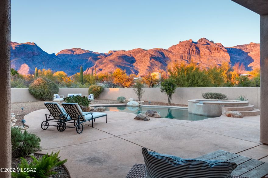 Unobstructed Catalina Mountain AND City Light Views from this single-story 3,411sf 4BR/2½BA w/pool/spa & 3 car garage on 1 acre lot. Perfect open floor plan w/high ceilings, travertine tile & large wood-cased windows. Foyer has lit coffered ceiling. Living Room has fireplace. Formal Dining Room. Kitchen has granite counters, large island w/raised breakfast bar, stainless appliances, Jenn-Air cook top, spacious pantry, 2 dishwashers, casual dining area, open to family room w/fireplace & media niches. Office alcove area w/built-in desk & cabinetry. Master suite has fireplace, large jetted tub, separate walk-in shower, custom organized closet & patio access. Secondary BRs are on opposite side of the home. Laundry Room has cabinets & laundry sink. Fantastic Private Foothills location on dead-end street yet just minutes to La Encantada shopping & restaurants.