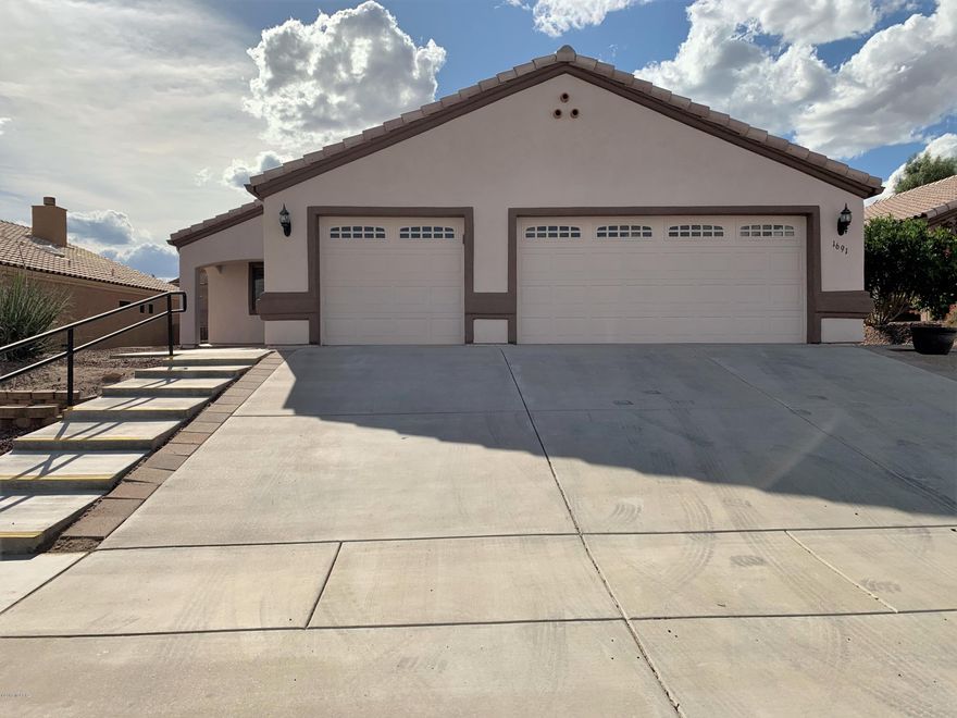 This meticulously maintained home will impress you the moment you walk in the front door. Your eye is immediately drawn to the beehive gas fireplace in the great room along with the soaring ceilings. With warm neutral paint, tile flooring throughout, extra recessed lighting and an open concept, this home is sure to make an impact. The large master looks out over the private back yard. The split bedroom floor plan allows your guests a private room and bathroom area. In addition, a 3rd bedroom can be utilized as an office or den. Step outside to the covered porch with extended patio pavers and enjoy the mountain view while soaking up the Arizona sunshine. The home does NOT have GVR, but it is available if the new buyer would like to opt in. Come see this amazing home today.