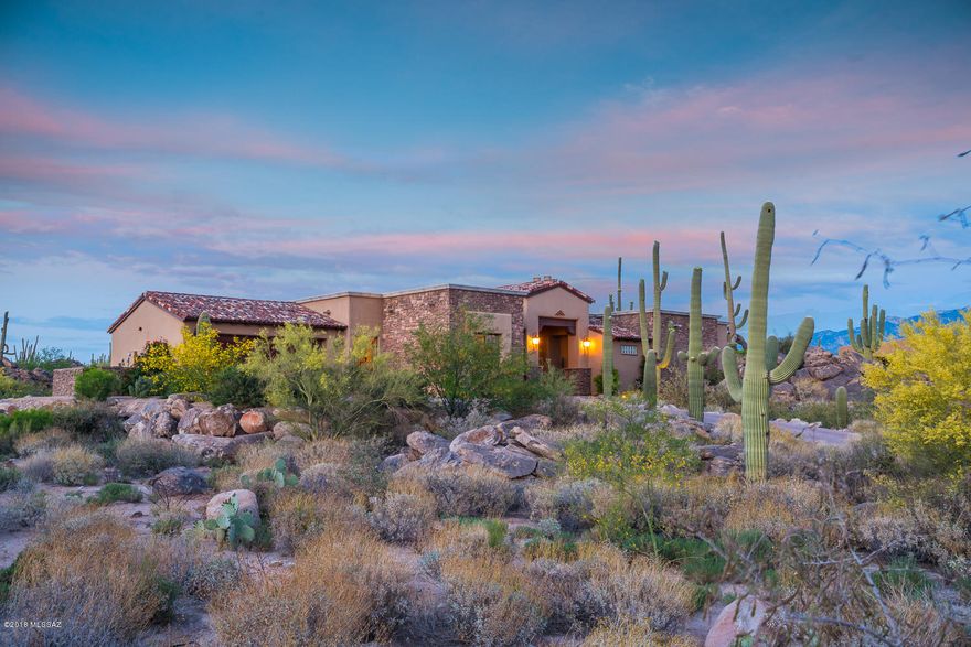 Privately nestled amongst incredible rock outcroppings and gorgeous saguaros. Feel quiet and tucked away in your own getaway. Easy lock and leave or year round home. Great room open floorpan concept with split room layout. All the beautiful finishes one would expect in a custom home including a gourmet kitchen with large prep areas.  Entertain with a seamless indoor/outdoor experience with the triple panel disappearing door. Grand Master BD & BA with large W/In Closet. Windows in every room provide a different incredible view in every direction. Enjoy the Stone Canyon lifestyle of fitness, world class golf and social activities. Tour of this home and amenities available 7 days a week. Adjacent Parcel also available for sale MLS#21804806.