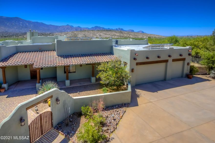 STUNNING CUSTOM HOME WITH BREATHTAKING VIEWS!! Situated against the Catalina Mountains and Miraval Resort and Spa, this 4 bed/3.5 bath home on a 1 acre lot will exceed your expectations! Enter through a front courtyard into a spacious Great Room with beamed ceilings!  The generous Primary Bedroom boast of a fireplace & luxurious en suite travertine-studded bathroom w/soaking tub, walk-in shower and a California closet! Entertain in the gourmet chef's kitchen with Jen Air appliances, curved island and custom alder cabinetry throughout.  Guest wing includes 2 bedrooms, each w/en suite travertine bathrooms and private patio access.   SPECTACULAR VIEWS FROM EVERY ROOM!! Venture out back to your private oasis with Koi Pond/waterfall, pool, outdoor kitchen and panoramic VIEWS! See More... 4th Bedroom is currently being used as an office with custom built-ins.  Huge 3-car garage with storage and cabinets, fully enclosed yards with double gates on each side for all of your toys or horses!  Close to BASIS school, medical facilities, shopping/dining, vineyards and endless trail systems/National Forest access.  Solar is owned. Shared Well Agreement.  Septic. NO HOA! Owner has invested $100K in upgrades since purchasing the home.