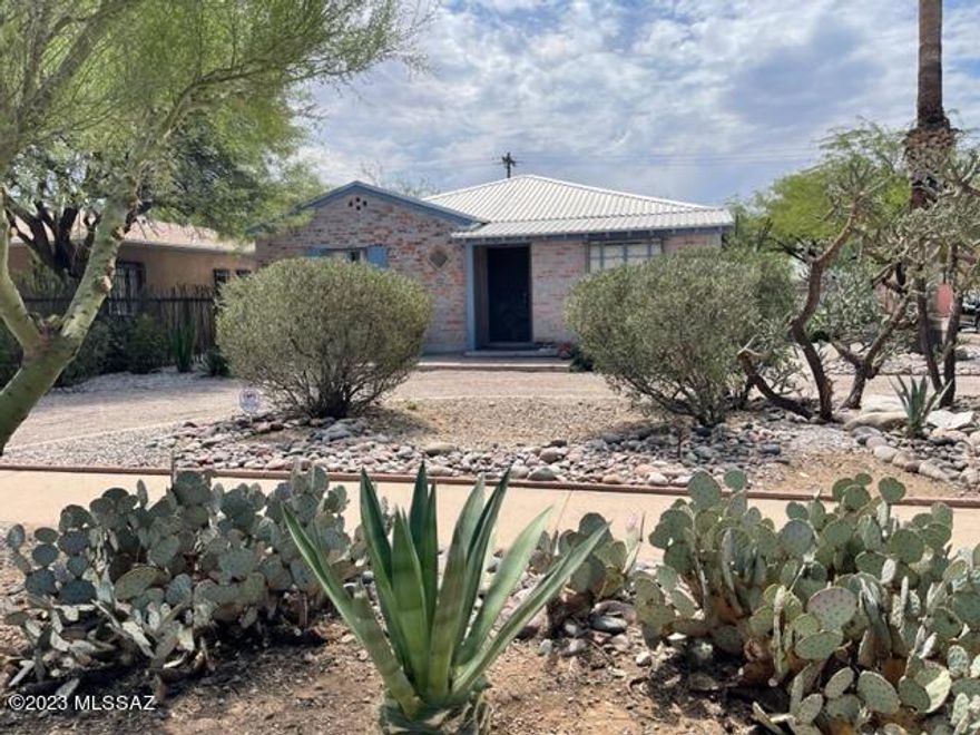 Very close to the University of Arizona, corner lot 3 bd 2 bath very nice home has a GARAGE that can potentially be a GUEST. No HOA. The home has been consistently rented, has been remodeled, &  shows extremely well. The hall & 3 bedrooms have original oak floors that look brand new. With high ceilings, the living room & kitchen are open to each other creating a Great Room look. The cabinets & counter tops are bright & clean & look new, & the butcher block island also looks like it was added yesterday. New furnace for the heating system. The back yard is fully enclosed, & leads to the separate garage, that has a small room for studying or a potential bedroom/kitchenette. The metal roof is a bonus. Nicely & newly landscaped.  Priced to sell. A great INVESTMENT