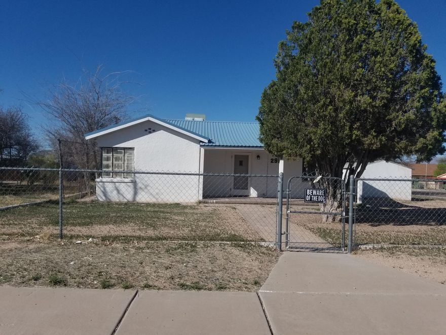 What a cutie! Older home on four city lots, fenced corner, in great location! Close to schools, library, restaurants, etc.. Two roomy bedrooms, full bath, freshly painted, new carpet. HUGE workshop, plus garage. Seller is Licensed Real Estate Broker in the State of Arizona.