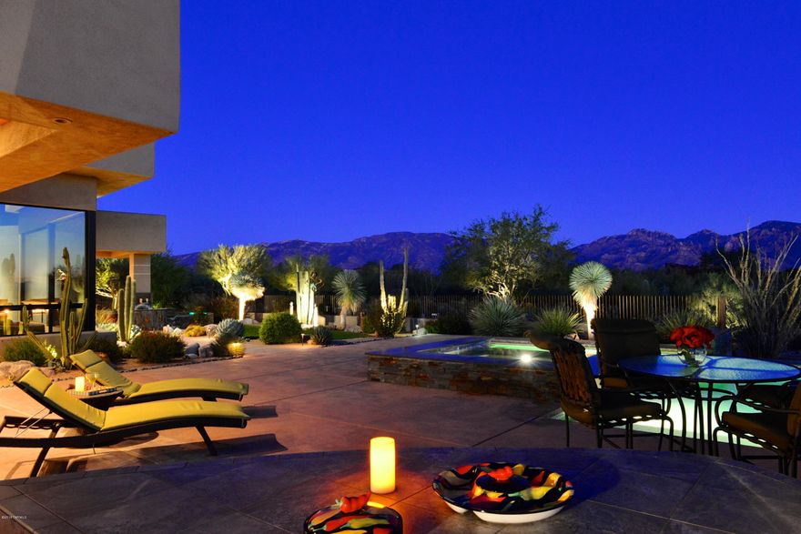 Panoramic VIEWS, open design and splendid appointments in exclusive guard-gated Stone Canyon! Impressive one-level 4,315 SF contemporary bordering open space evokes sense of serenity, melding tasteful modern design with easy AZ-lifestyle amenities. Grand Great Room with walls of windows (automated shades), curved Fpl/Media wall, and spacious Upscale Kitchen creates superb entertainment and relaxation spaces complimented by similar patio areas (BBQ kitchen, fountains, pool, spa, Fpl/Media sitting area). Split layout with Office, 2 Guest Suites, 2 Powder Rooms (one for pool), Exercise/Media, and Master Suite with Fpl, sumptuous bath (2 toilets, separate vanities, 2 showers), and huge custom closet. Large paver motor-court and 3-car garage with cabinets and storage room. Absolute perfection!
