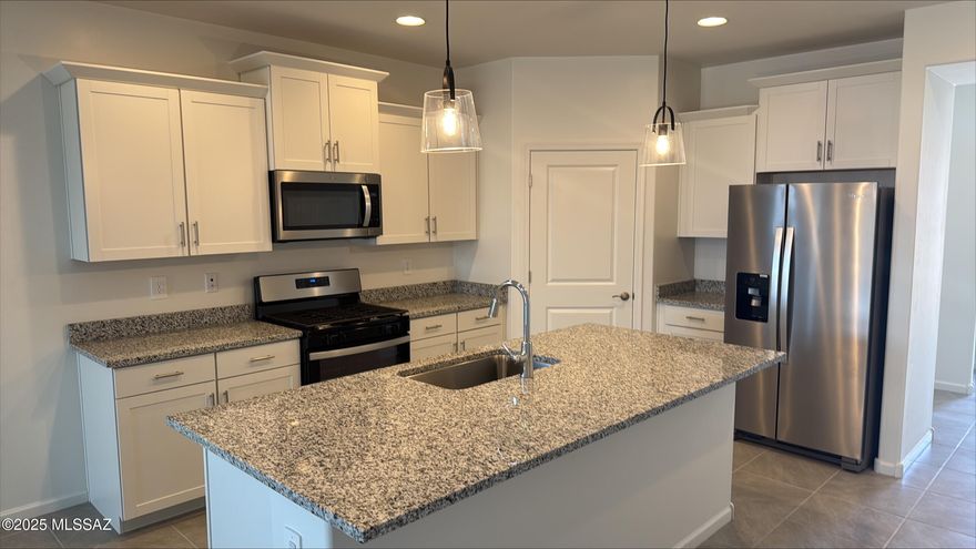 This spacious 4-bedroom, 3-bathroom home is thoughtfully designed for modern living. The versatile teen room offers the perfect additional space for homework, TV, or gaming. The primary suite features dual sinks and a generous walk-in closet for added comfort and convenience.

Stylish interior finishes include white cabinetry, cream and black granite countertops, travertine-look tile flooring, and warm neutral carpet throughout. Plus, this energy-efficient home is designed to help you save on utility costs—comfort meets smart living!