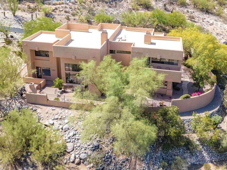 Custom home on 1.7 acres built in 1996 and updated in 2012 with unobstructed North facing Catalina Mountain Views.  Open concept floorplan offers large rooms, a flowing floorplan from  the living and dining rooms into the breakfast area, kitchen and family room (see floorplan). 4 bedrooms + loft/3 full baths.  Don't miss the bonus play room/under stairway storage to the left of the front door! Kitchen features Cherry cabinets, center island with Bosch cooktop, pantry, Granite slab finish on the counters/ kitchen sink & stainless appliances. Two indoor fireplaces, 3 car garage with built-in cabinets/separate storage area. Low maintenance patios w/BBQ grill & fireplace. A pool can fit on this lot! The seller has obtained a quote from Omni Pools. Call listing agent for details. The Seller has an allergy to chemicals and does not use any chemicals to clean the home. This is one of the cleanest homes I have ever seen. Must see!